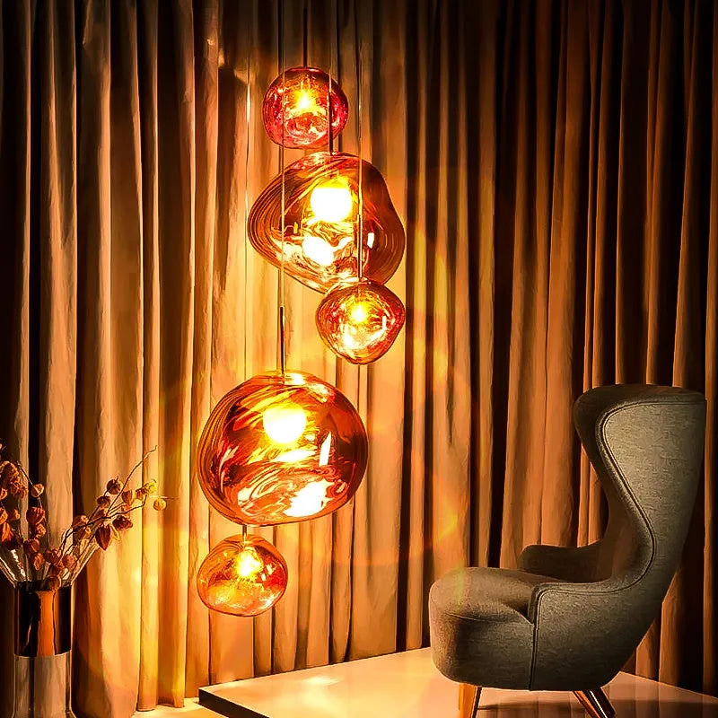 Nordic post-modern chandelier with irregular lava lamp glass design in gold finish.