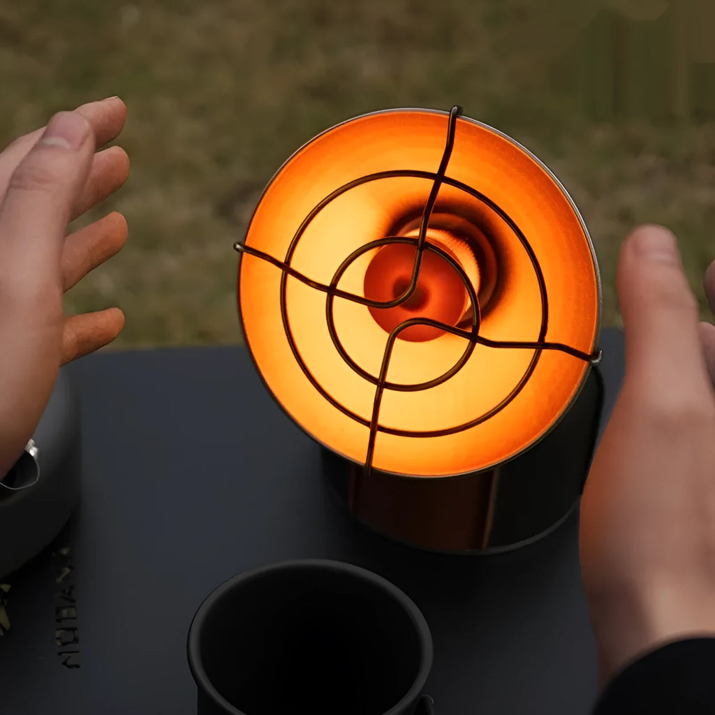 Black and orange portable outdoor heater stove with automatic ignition for camping.
