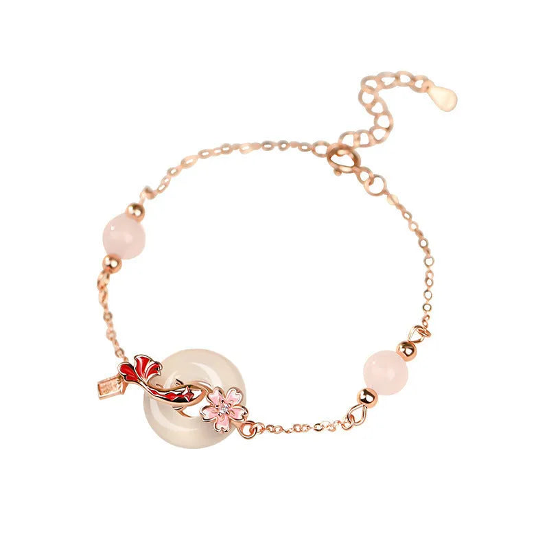 S925 sterling silver bracelet with white chalcedony beads and a gold-toned koi fish charm.