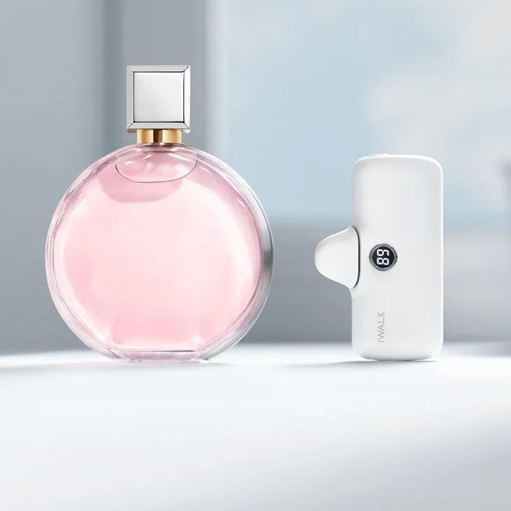 White mini lipstick-shaped power bank showing built-in screen display on black background