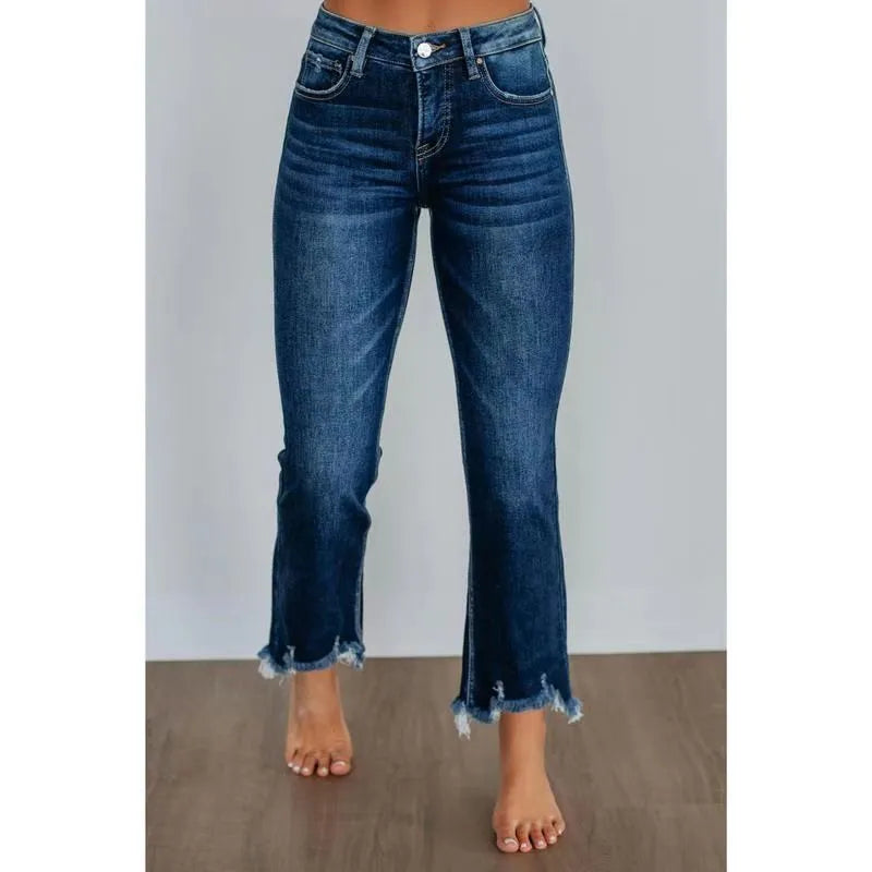 Women's dark blue denim casual trousers with a hand-distressed finish on a hanger.