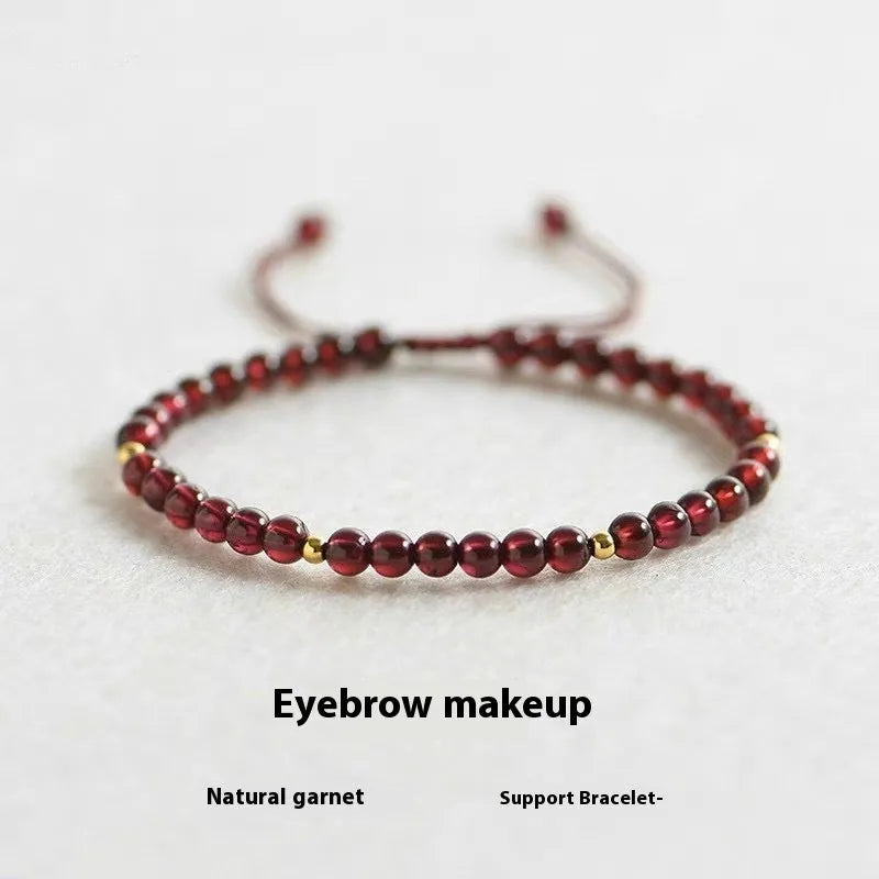 Hand-woven garnet red rope bracelet with flexible wire on a neutral background.
