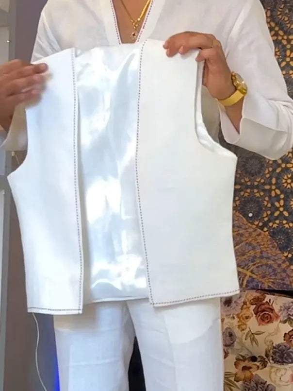 White women's three-piece outfit comprising a V-neck shirt, sleeveless vest, and full-length trousers.
