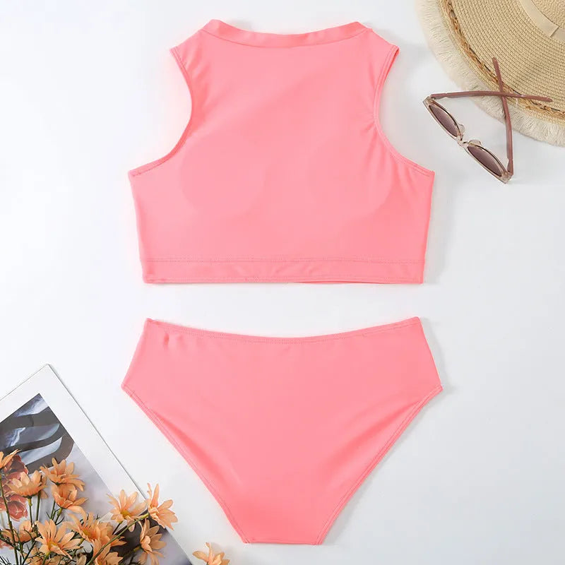 Pink high waist bikini swimsuit with briefs and a bra on a neutral background.