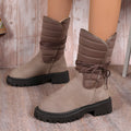 Women's black suede snow boots with chunky heel, fleece lining, and lace-up design.