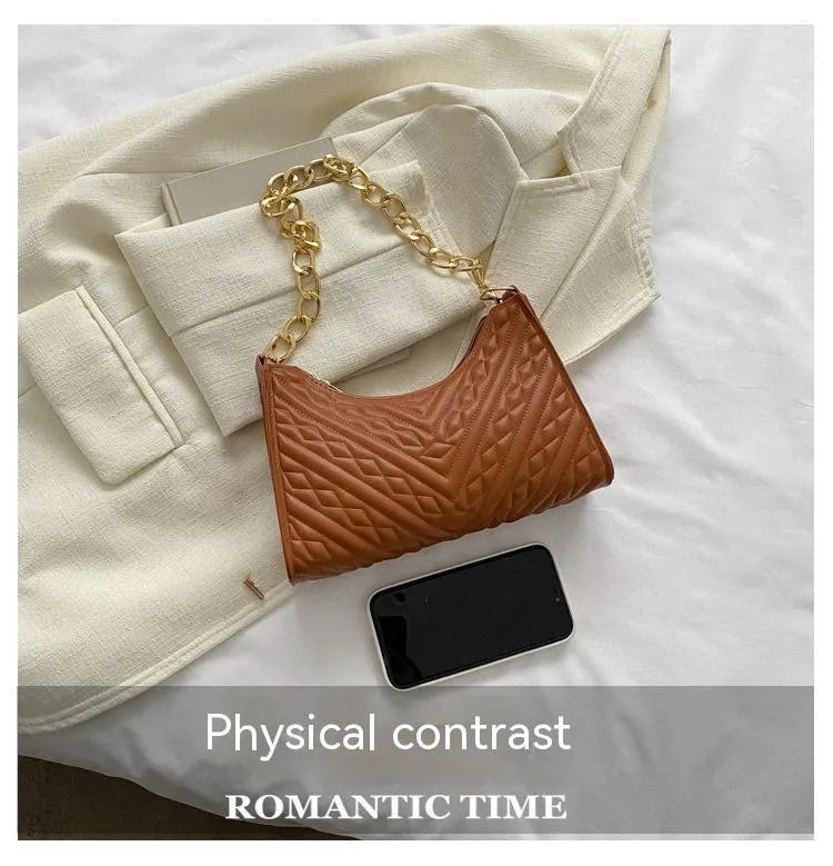 Vertical brown PU leather women's shoulder bag with a pleated front, chain strap, and soft handle.