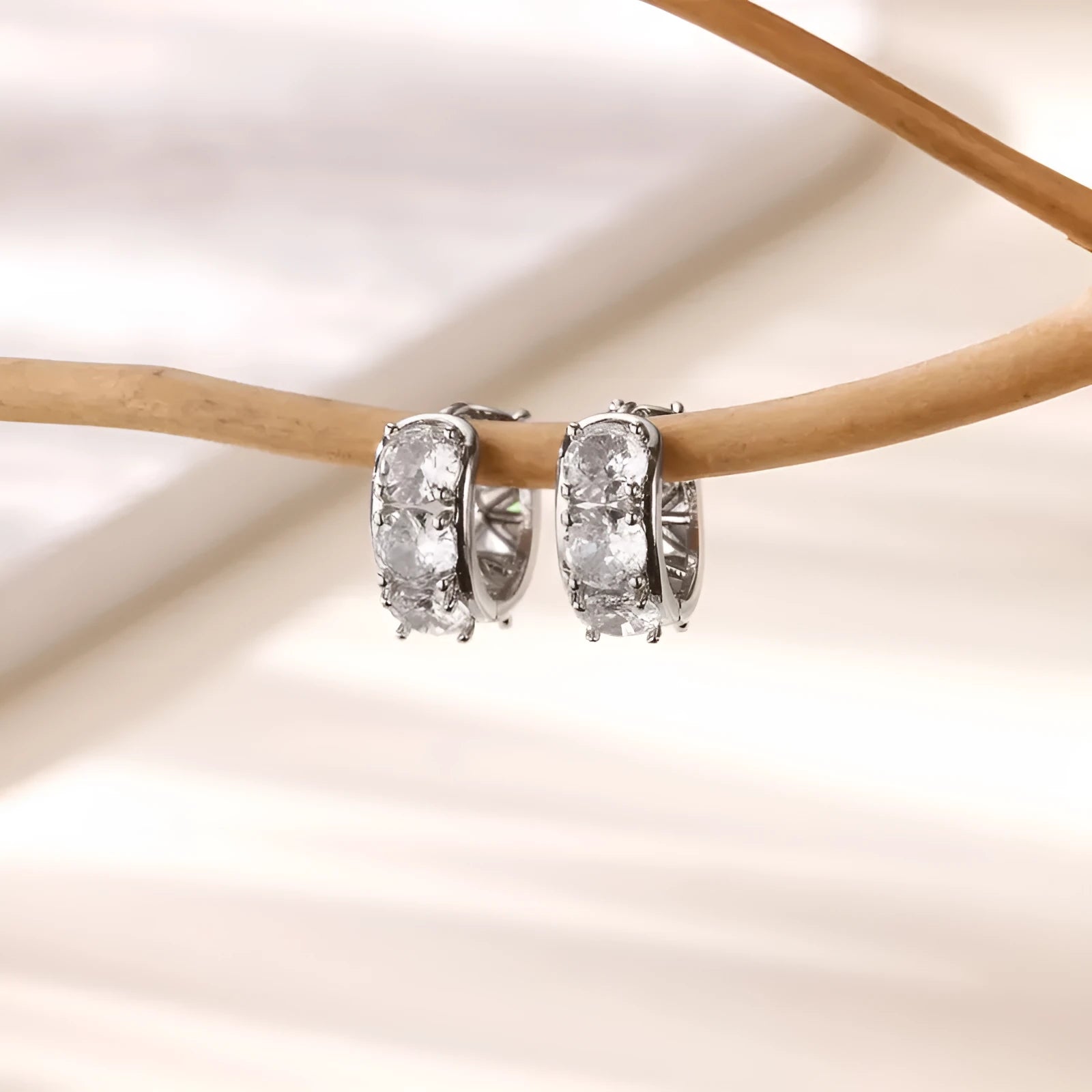 Gold-tone stainless steel U-shaped women's clip earrings with sparkling zircon accents.