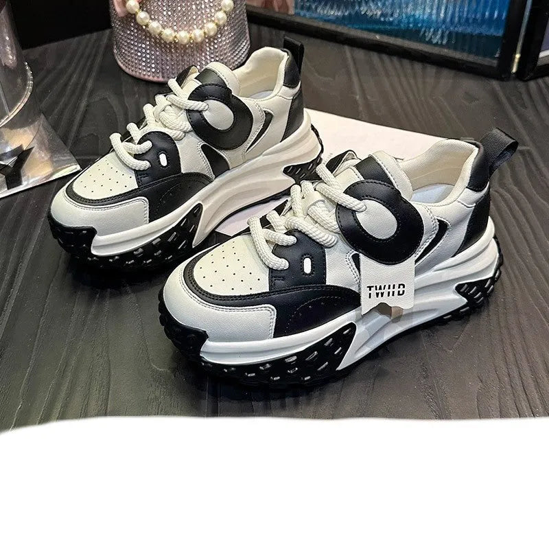 A pair of thick-soled leather sports casual shoes with a wedge heel and round toe in a lace-up design.