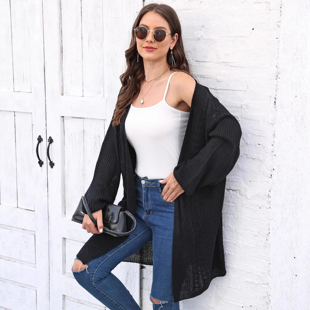 Women's loose-fitting solid colour acrylic sweater coat on a hanger