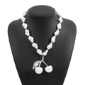 Women's creative necklace with gold alloy cherry fruit pendant on a white imitation pearl chain.