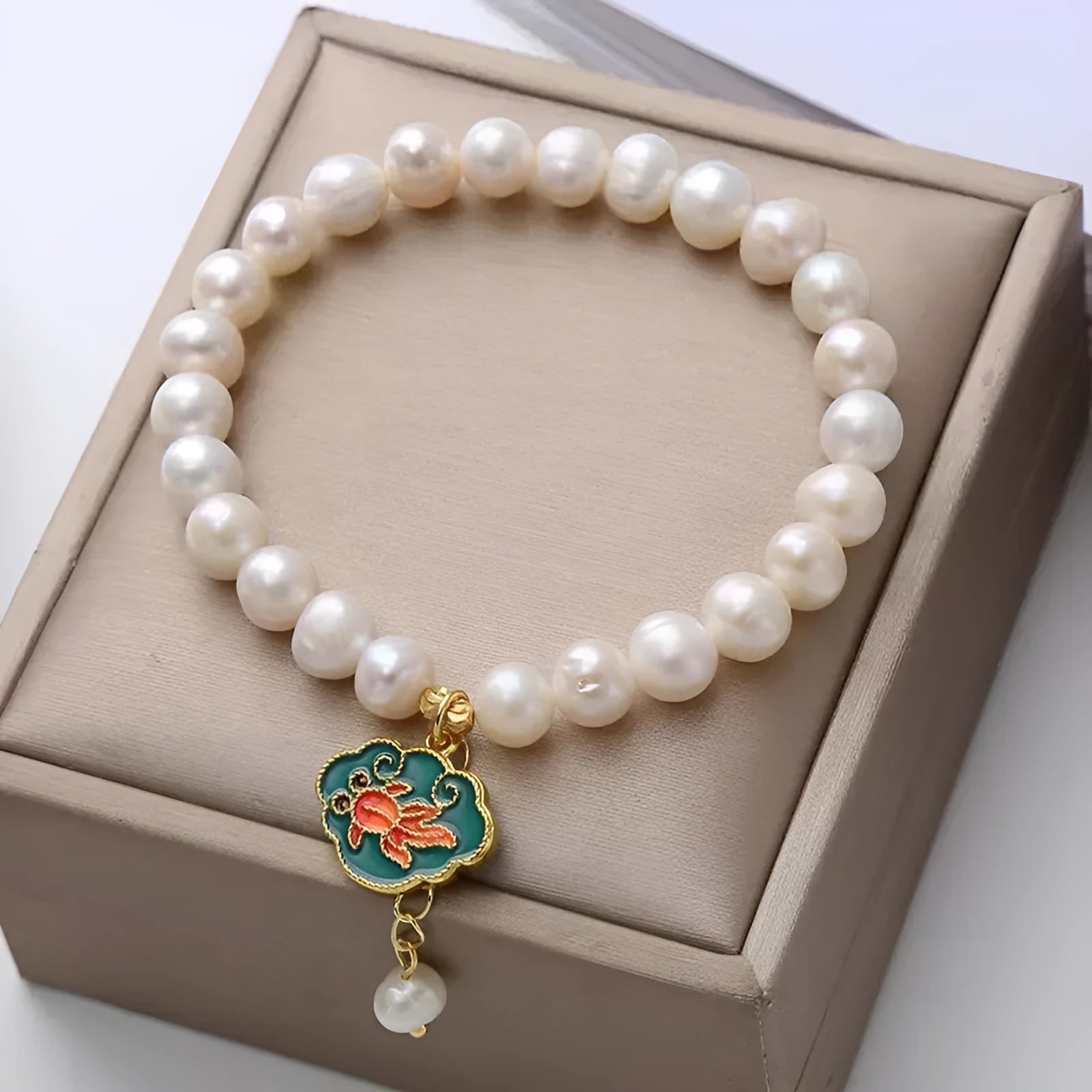 White vintage baroque bracelet with a freshwater pearl and goldfish lotus pendant.