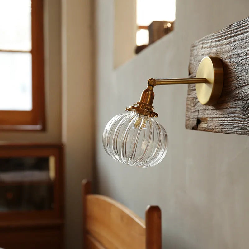 Creative pumpkin-shaped glass wall lamp in blue and transparent glass finishes for living room or bedroom.