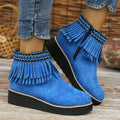 Women's dark brown suede ankle boots with a thick wedge sole, side zip, and decorative tassel.