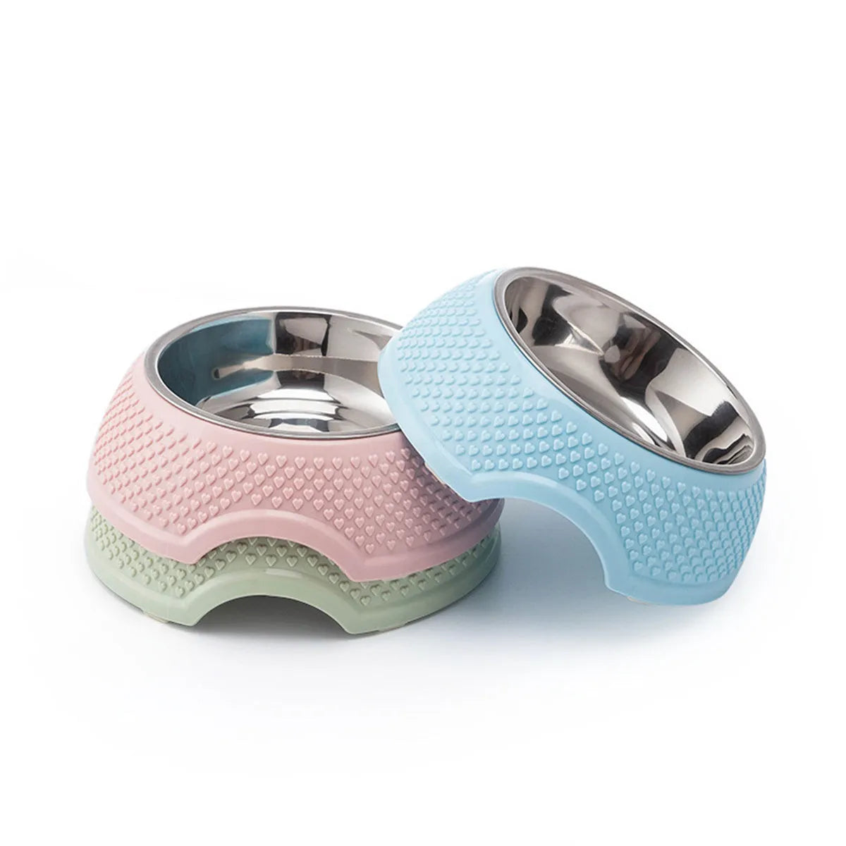 Set of four coloured stainless steel pet bowls with non-slip bases on a table.