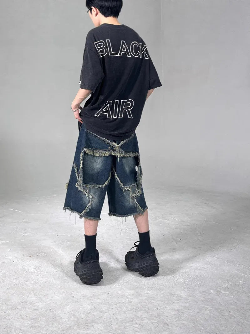 Blue denim shorts with frayed five-pointed star detailing and loose retro styling