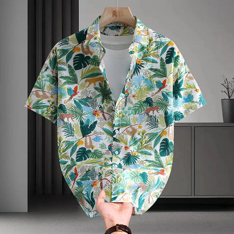 Man wearing a short sleeve cotton Hawaiian shirt with a blue and white floral print.