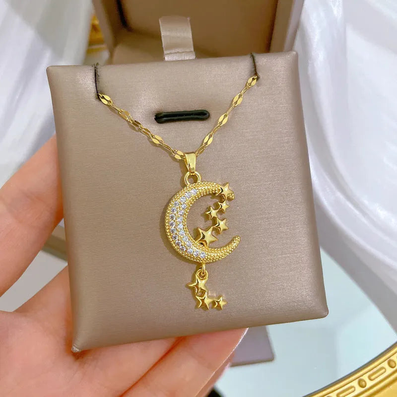 Geometric moon tassel necklace with diamond detail on a stainless steel chain.