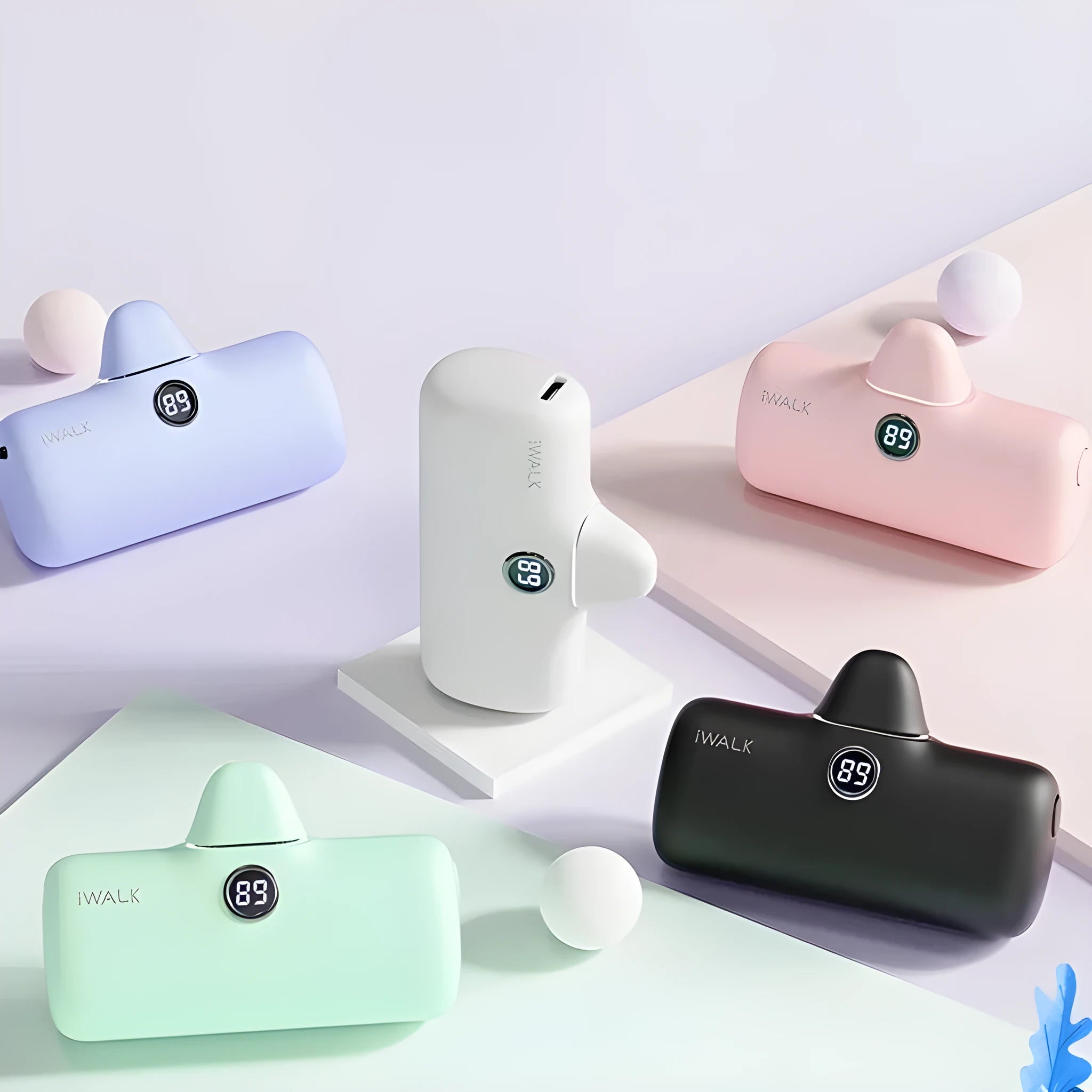 White mini lipstick-shaped power bank showing built-in screen display on black background