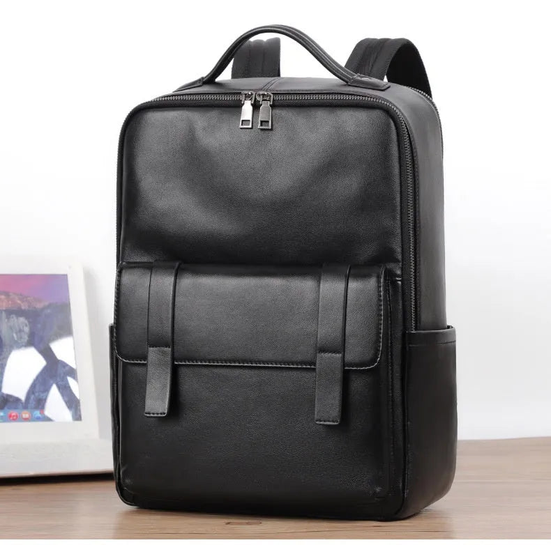 Black genuine leather men's laptop backpack with woven details and adjustable straps.