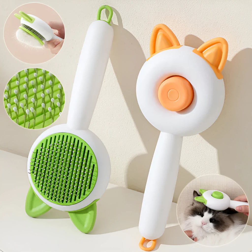 Greenish white cat grooming brush with stainless steel teeth and a self-cleaning button on the handle.