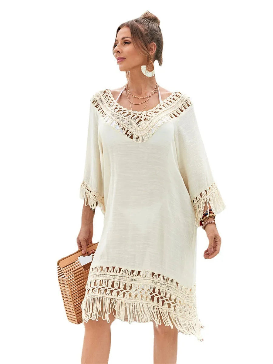 Apricot coloured hand-crocheted women's long beach dress with a lining, shown on a model.