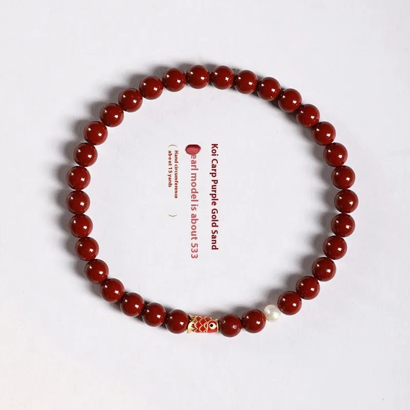 Hand-woven purple gold sand and strawberry quartz koi bracelet with crystal and pearl beads on a light background.