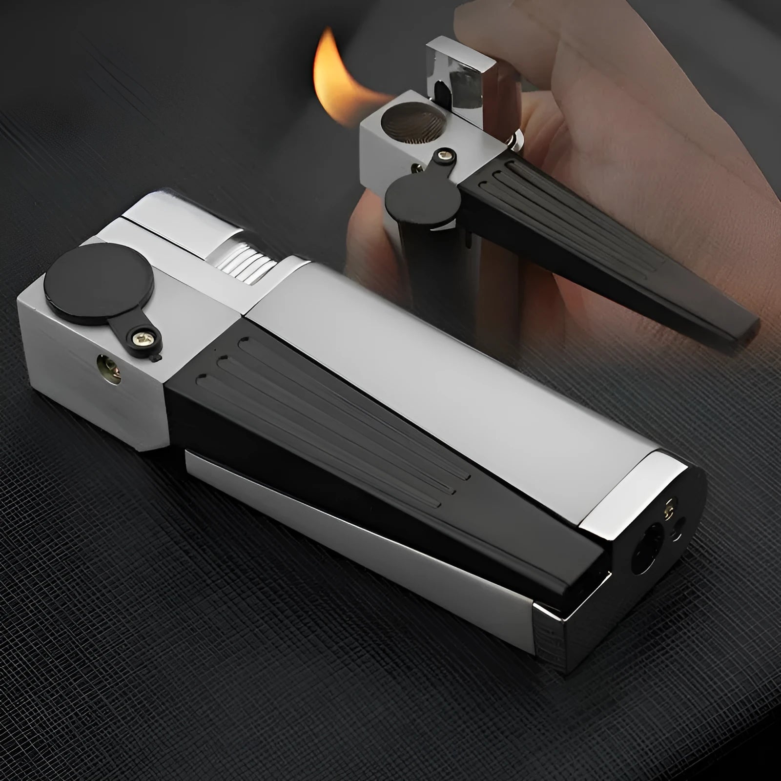 Silver foldable metal pipe lighter in open position showing flame mechanism and storage compartment.