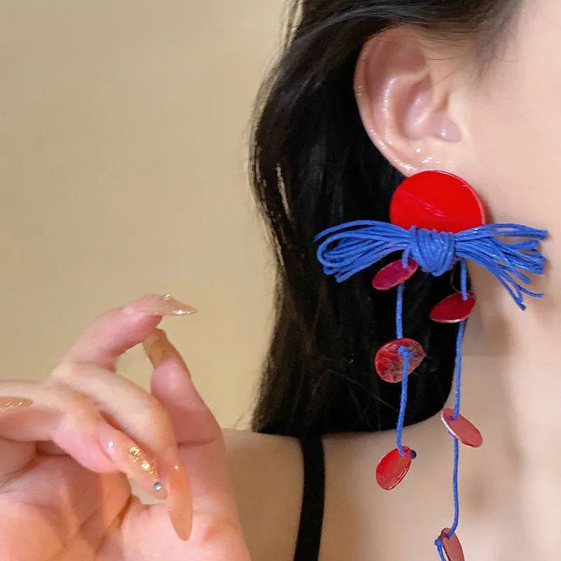 Geometric-shaped cloth earrings in silver needle and blue resin flower colours.