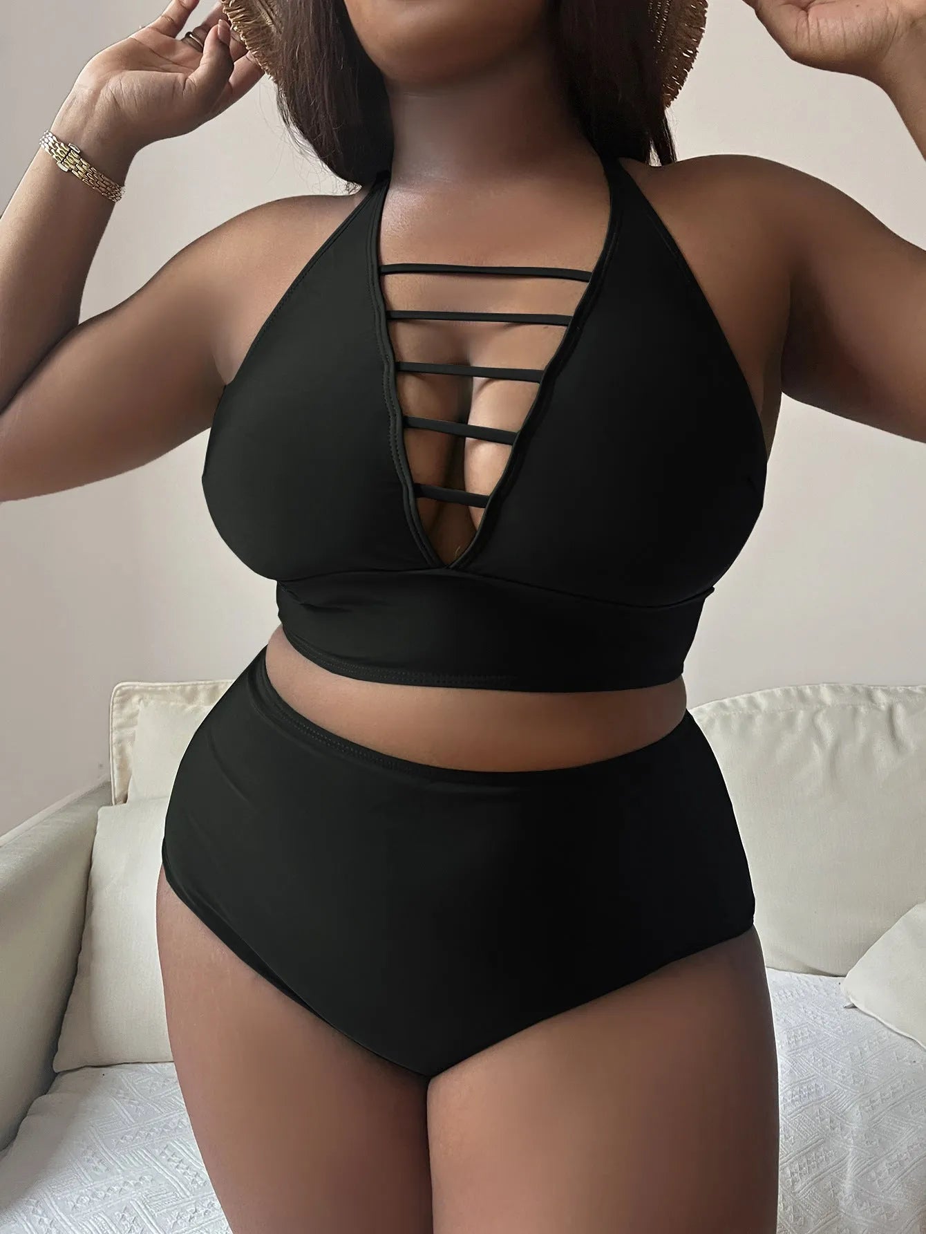 Plus size black halter bikini with adjustable straps and high-waist briefs on a mannequin.