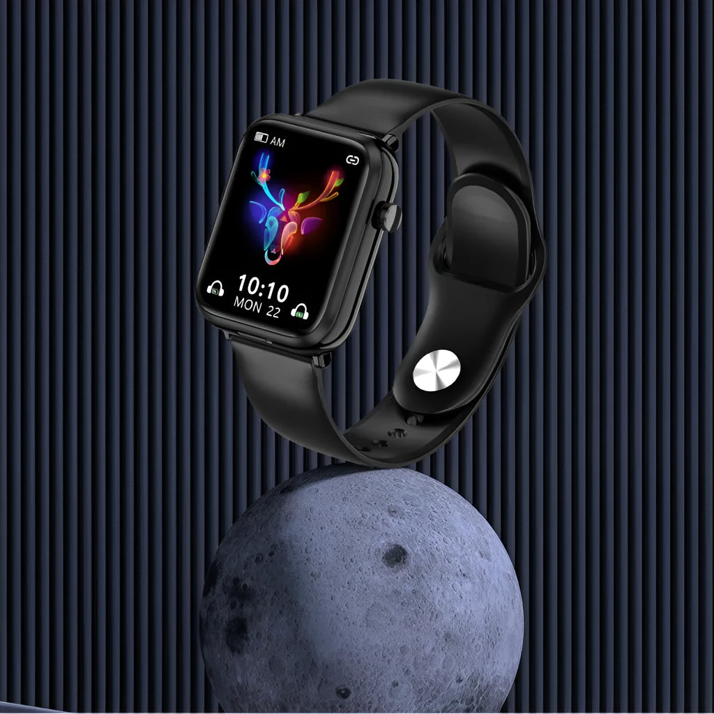Black smartwatch with touchscreen paired with wireless earbuds on a charging cable.