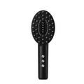 KD3802 black scalp vibration massager device with charging cable on a neutral background.