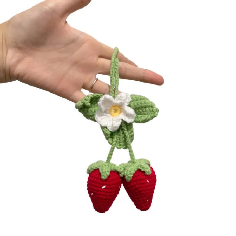 Handmade crochet strawberry-shaped car pendant made from cotton and hemp yarn.