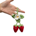 Handmade crochet strawberry-shaped car pendant made from cotton and hemp yarn.