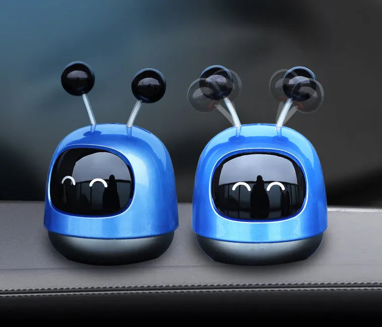 Robot-shaped car vent clip air freshener with aromatherapy gel in blue, grey, or red colour options.