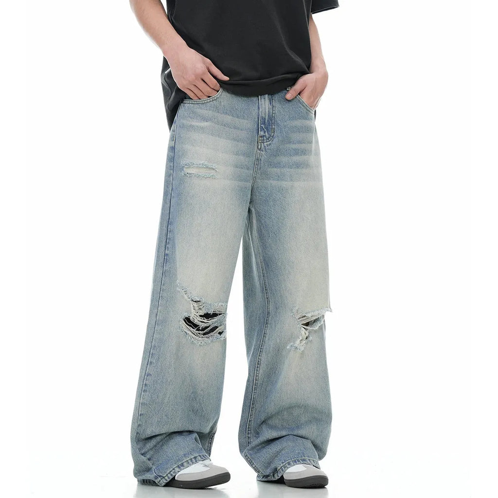 Blue straight-leg jeans with ripped detailing on cotton blend fabric