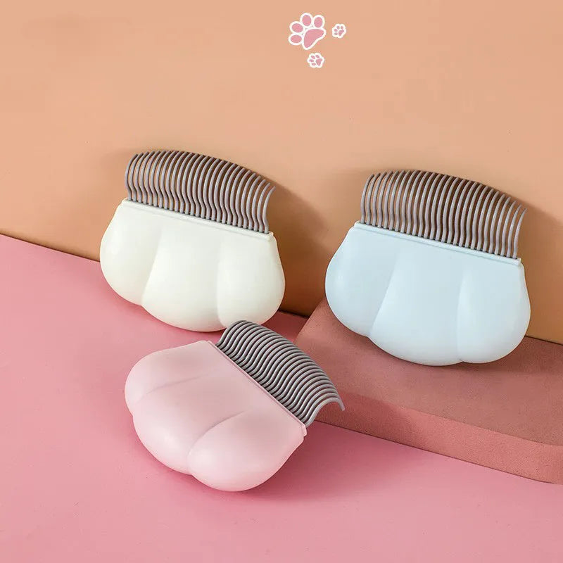 Paw Soft deshedding brush for pets in blue, pink, or white, showing 9x9 cm size.