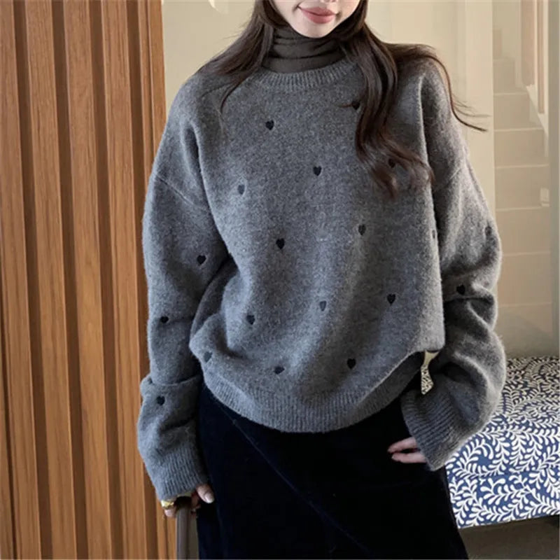 Women's loose grey acrylic pullover sweater with love-pattern embroidery on the front.