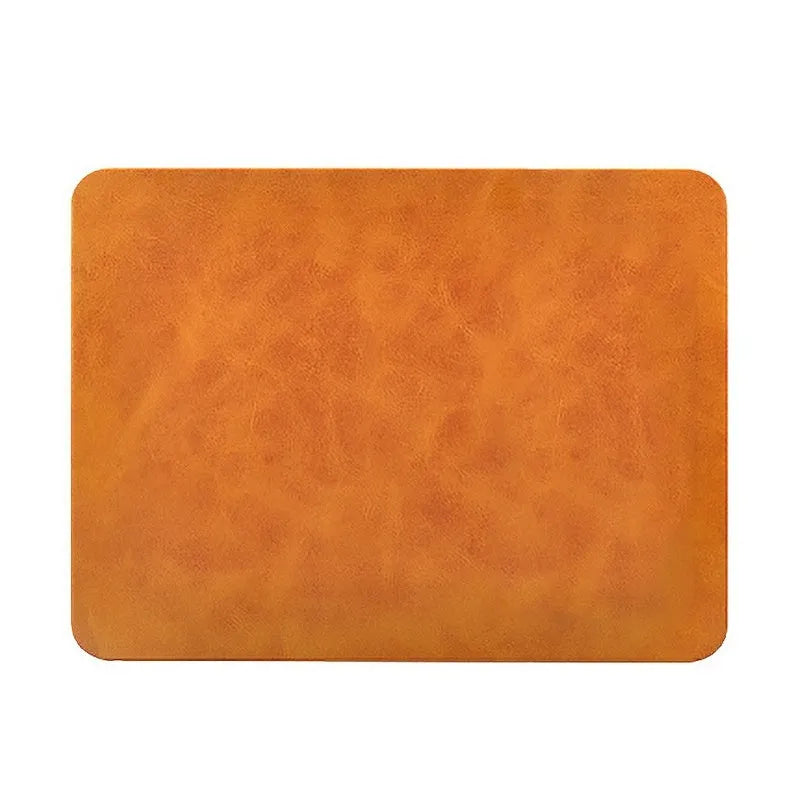 Brown leather desk mouse pad with integrated wireless charging for mobile phones.