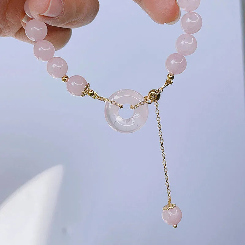 Pink crystal peace buckle bracelet with safety clasp on silver-coloured chain
