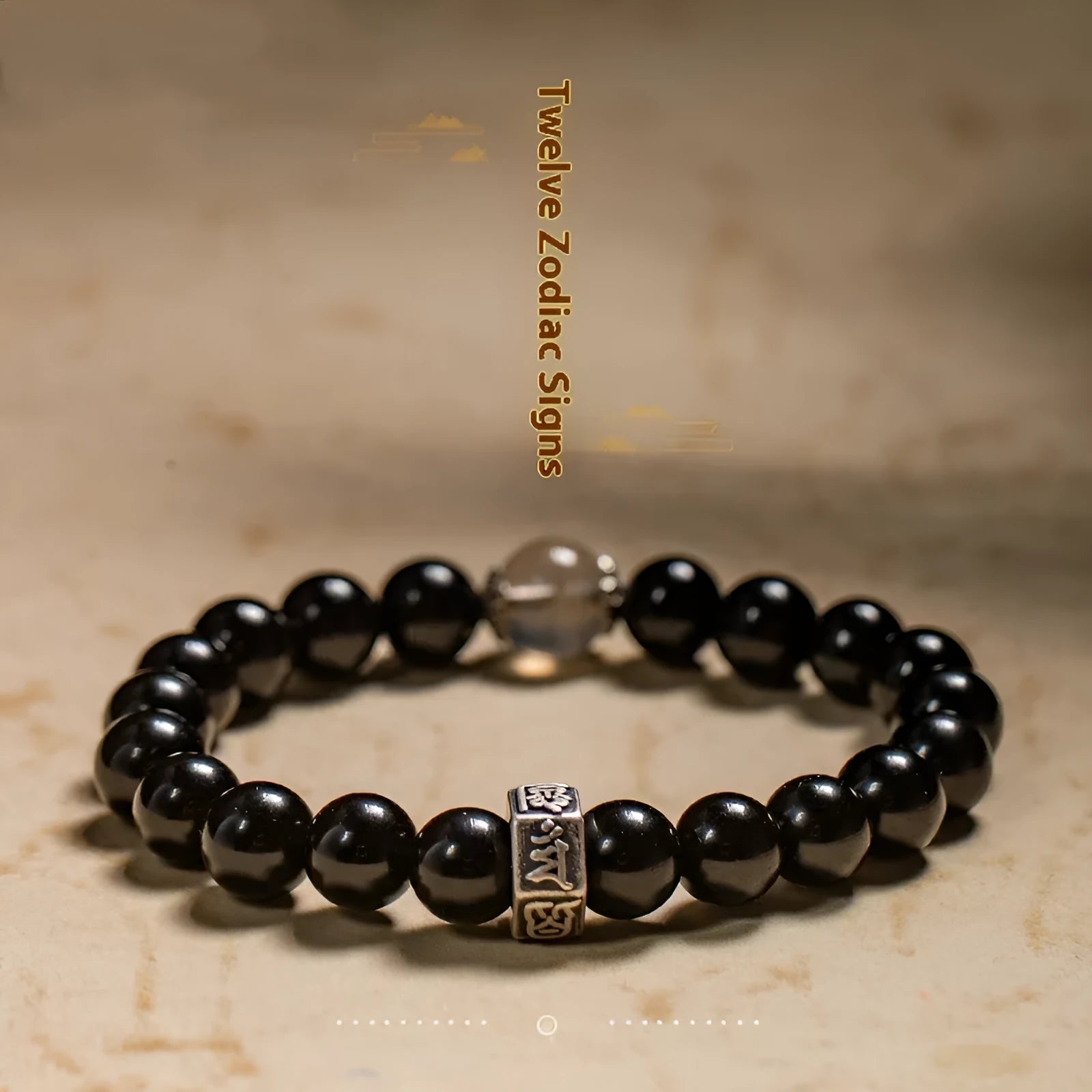 Black obsidian bracelet with 8mm beads carved with Zodiac animal and Buddhist bodhisattva designs.