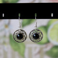 Handmade Miao silver and turquoise geometric flower disk earrings with ethnic patterns.