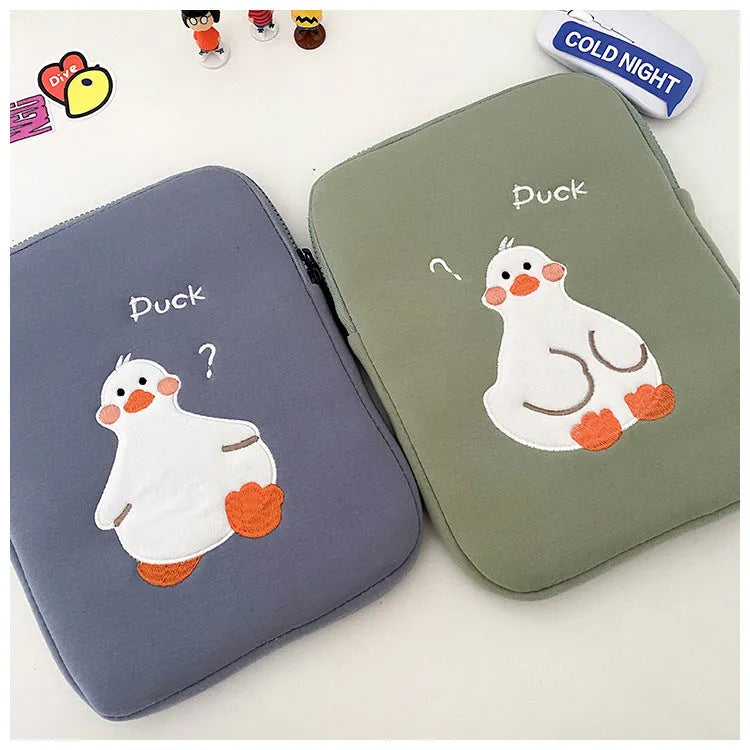 Blue cotton iPad case with embroidered cartoon duck design and a zipper.