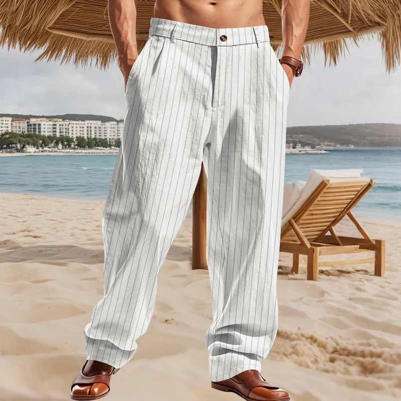Man wearing loose-fit high-waist striped linen trousers in a light blue colour.