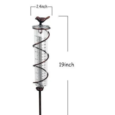 Cast iron bird ornament with glass rain measurement tube showing 0-800ml capacity scale