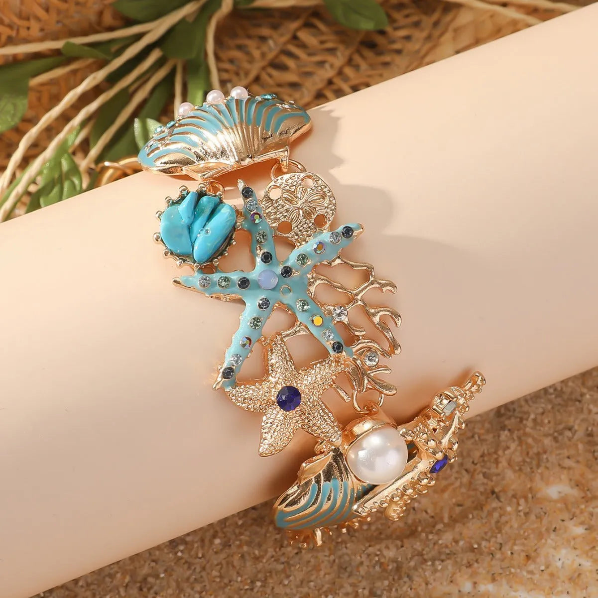 Alloy nautical bracelet with boat anchor charm, starfish detail, in turquoise, red, or blue.