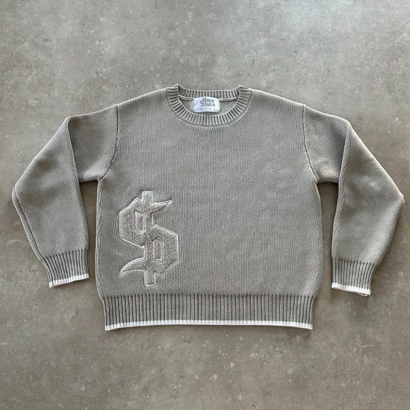 Grey loose-fitting jacquard knitwear coat with long sleeves on a hanger.