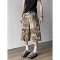 Yellow women's jeans with snake camouflage pattern and cropped leg length.