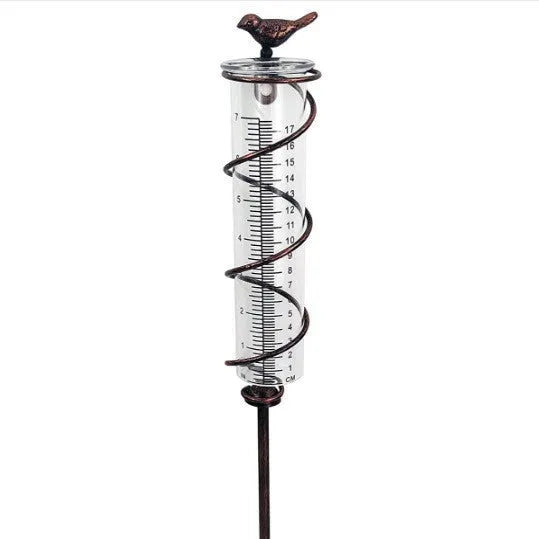 Cast iron bird ornament with glass rain measurement tube showing 0-800ml capacity scale