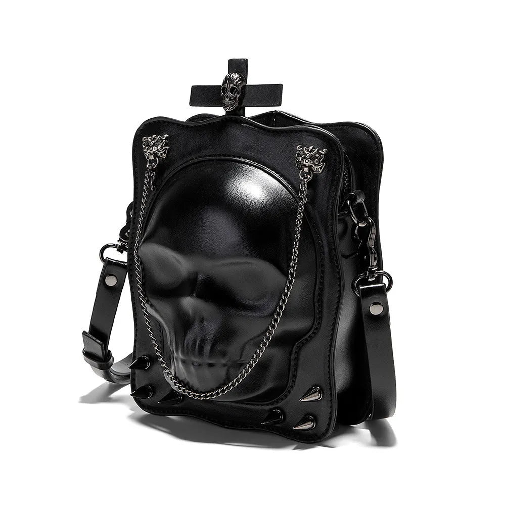 Black vertical square PU leather crossbody bag with embossed skull design, stitching, rivets, and a chain strap.