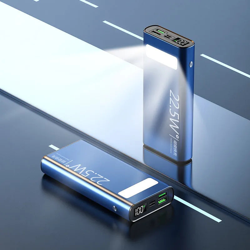 Black alloy 20000mAh power bank with LCD display showing battery level and USB ports.